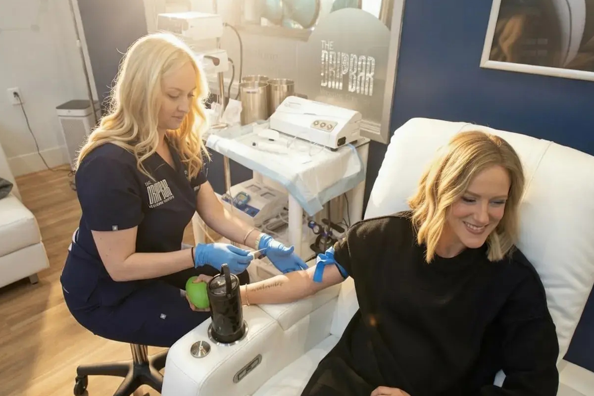 A nurse starting an IV for a guest